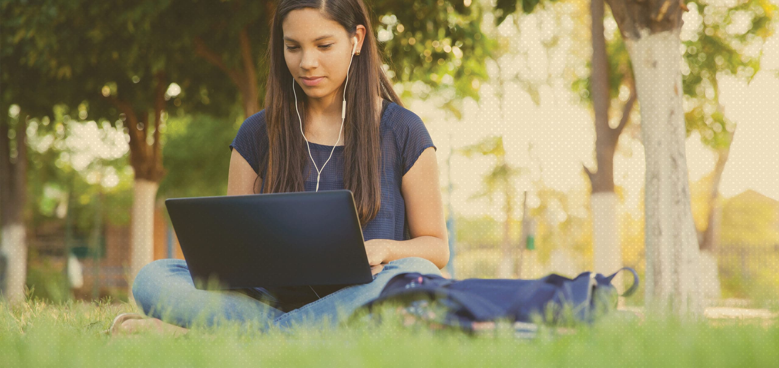 Student working outside on a laptop