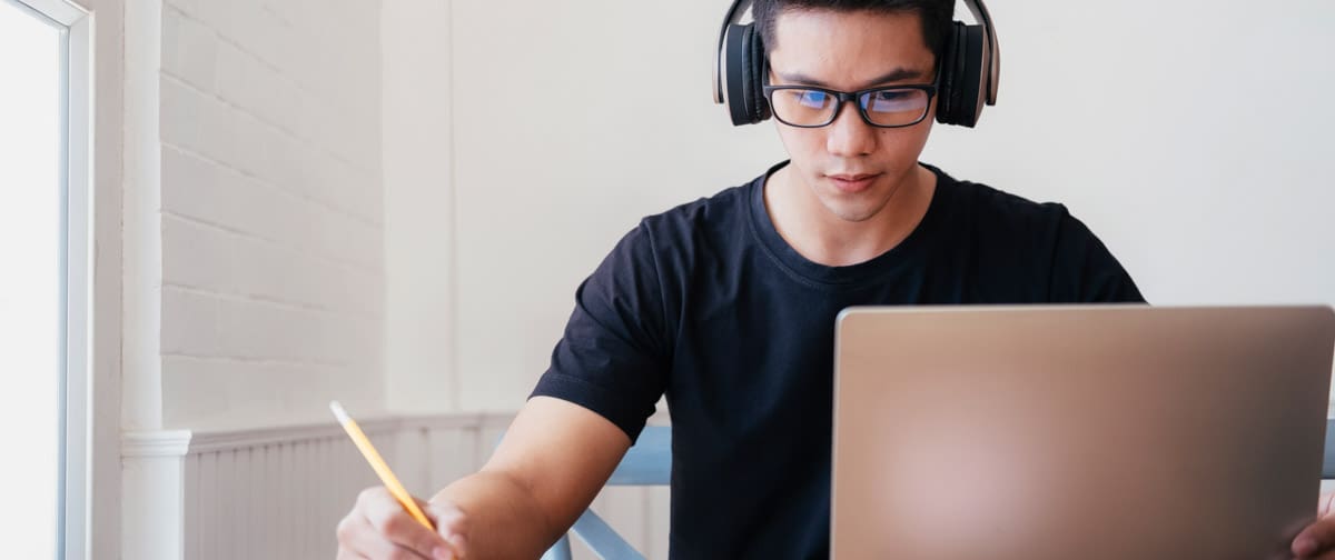 Young man student study at home using laptop and learning online.