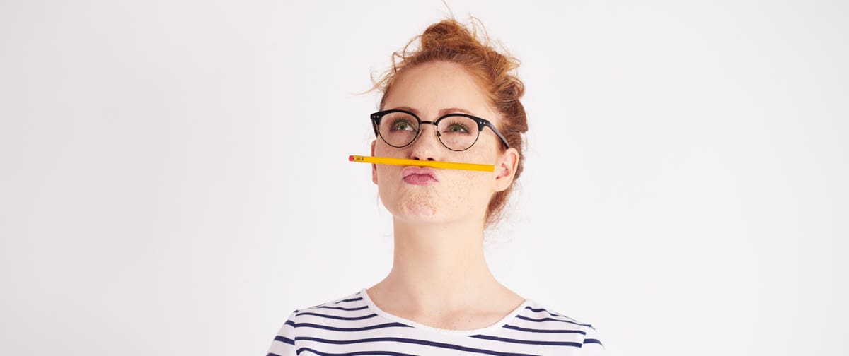 Bored woman having fun with pencil