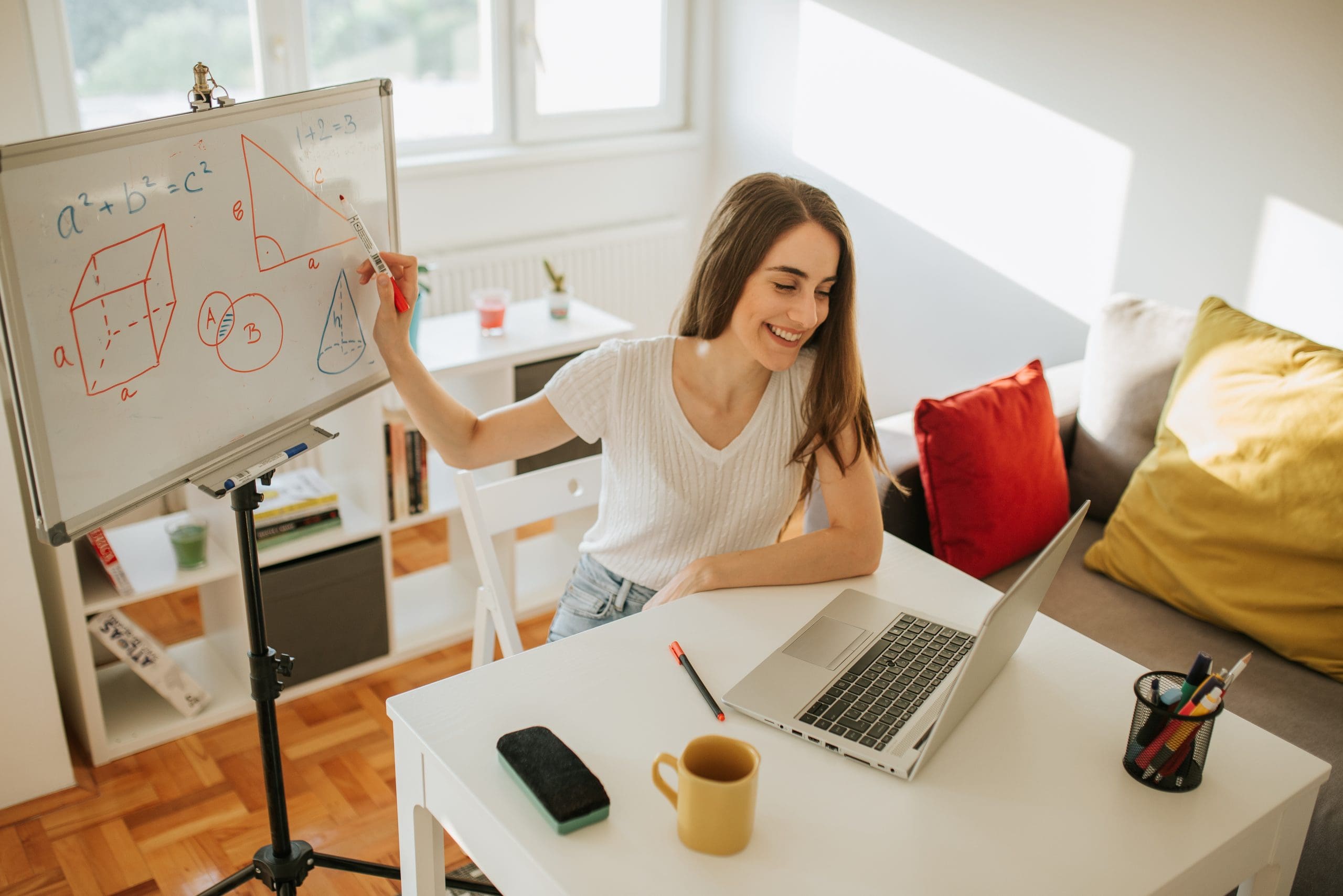 Young female teacher is having online class and showing Pythagorean theorem