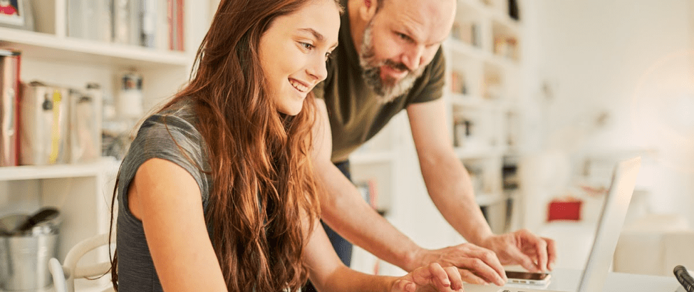 Dad and daughter study on a computer