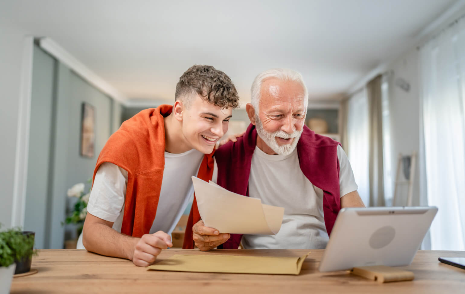 Student and guardian looking at college acceptance package